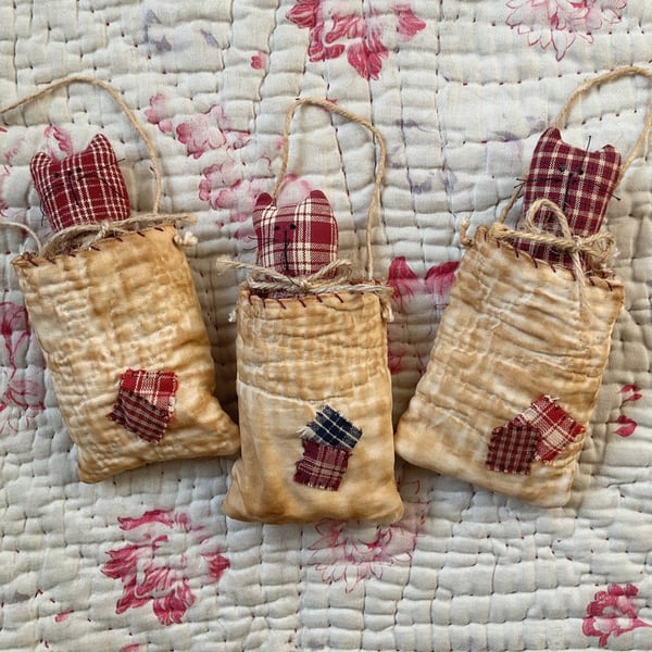 Kitten in vintage quilt pocket