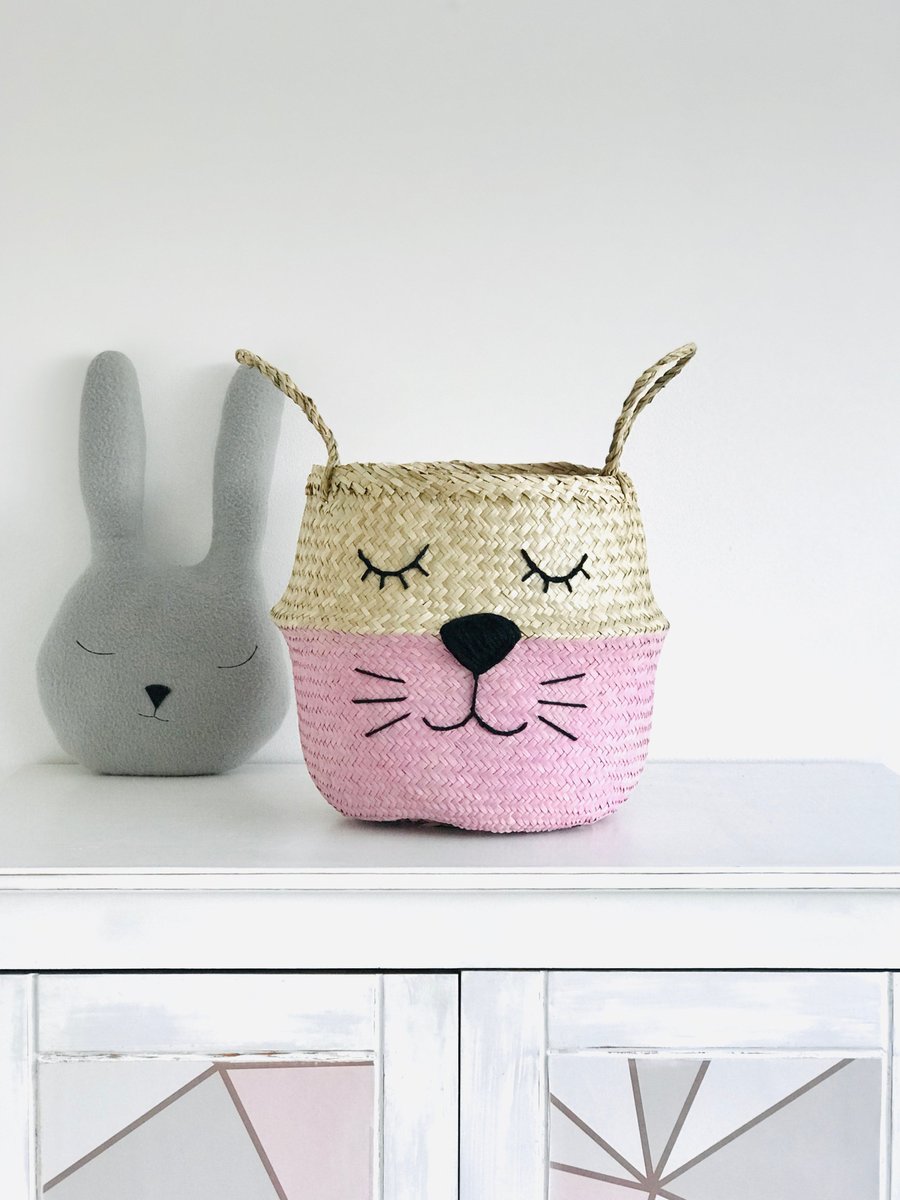 Pink animal belly basket. Cat with eyelash cat whiskers face. Hand woven