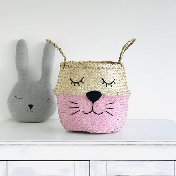 Pink animal belly basket. Cat with eyelash cat whiskers face. Hand woven