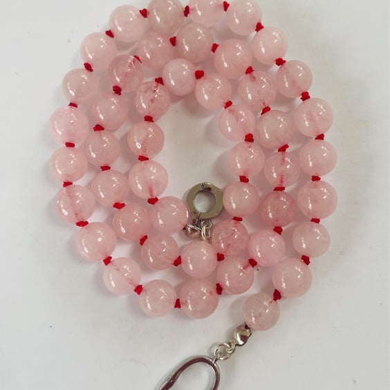 Rose quartz beaded necklace strung on red silk 