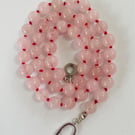 Rose quartz beaded necklace strung on red silk 