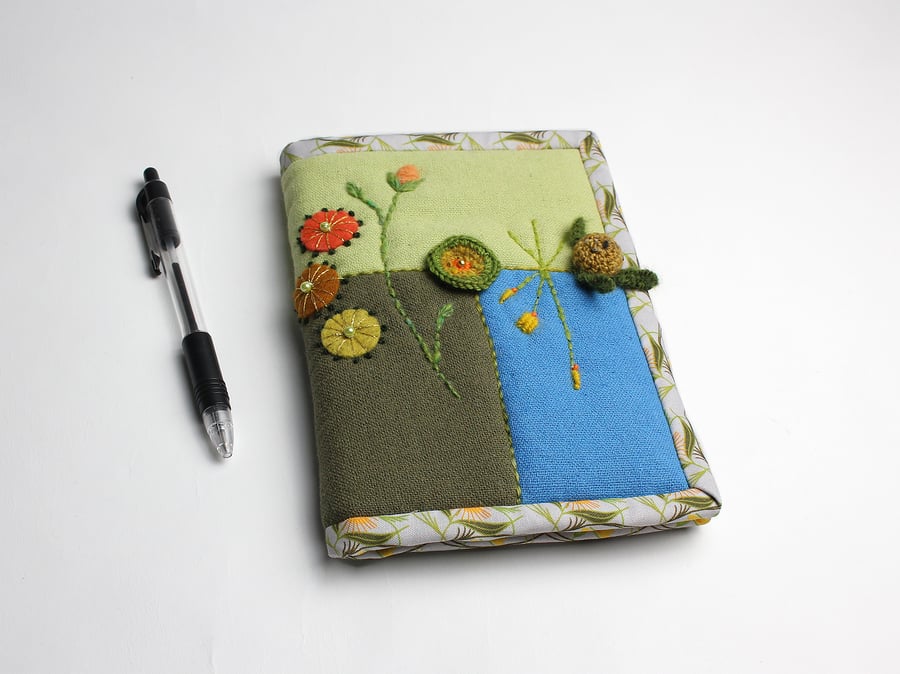 A6 notebook in three colours of linen with hand embroidered posy chain
