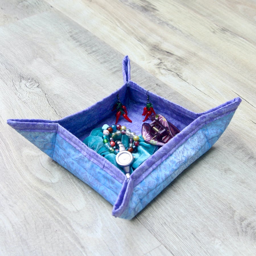 Quilted storage box featuring glittery blue and purple fabric.
