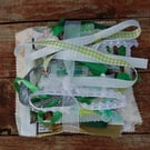 Upcycled slow stitching kit includes fabric, buttons, thread, lace, ribbon