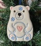 Ceramic polar bear with a pink heart