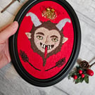 Krampus hand embroidery in black frame