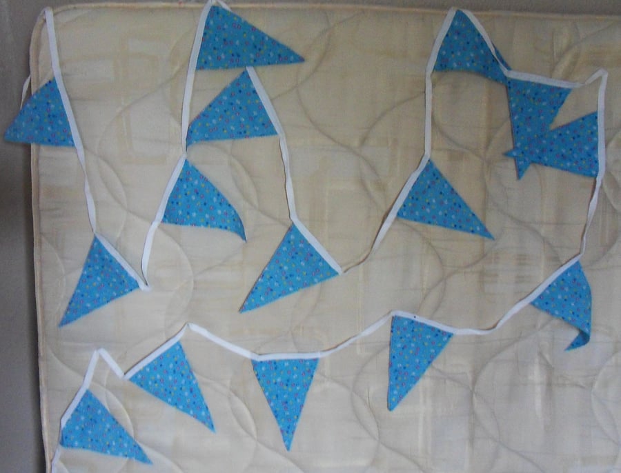 Homemade bunting.  Flowers on blue background. 5 meters