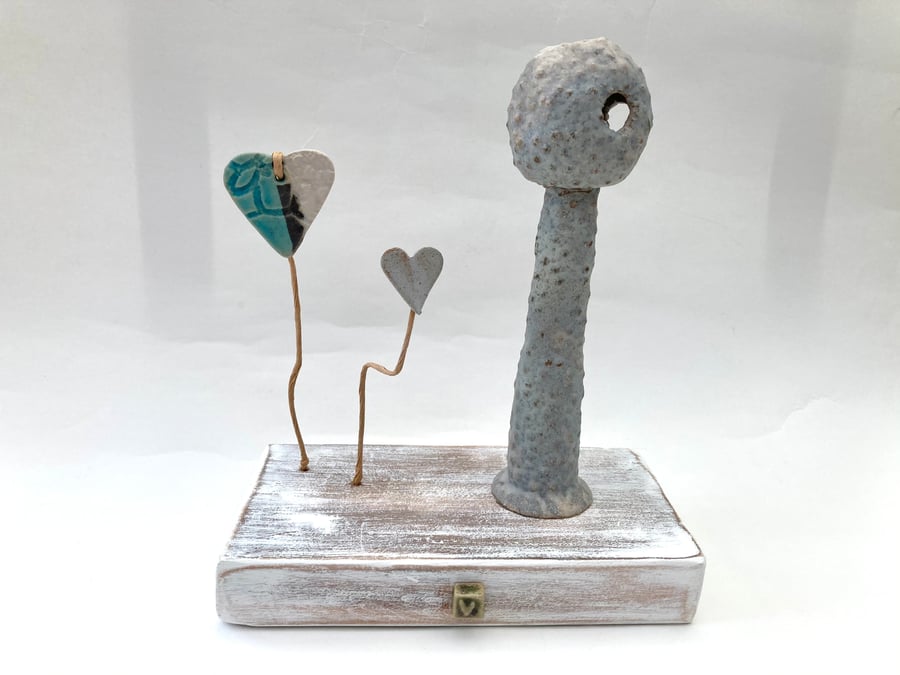 Clay sculpture on wood, ceramic art, clay creature, home decor