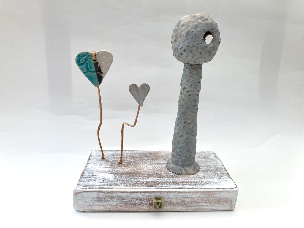 Clay sculpture on wood, ceramic art, clay creature, home decor