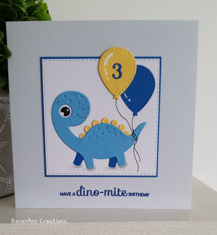 dinosaur birthday card for boy or girl  with personalised age balloon. 