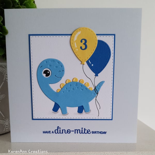 dinosaur birthday card for boy or girl  with personalised age balloon. 