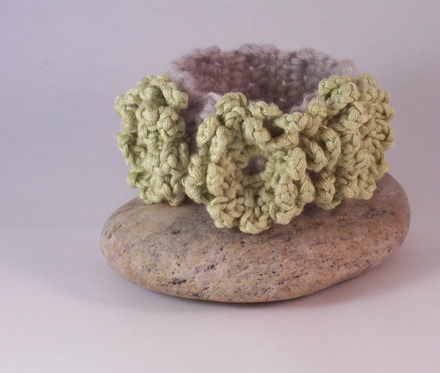 Crochet cuff with flower blossoms in soft lime