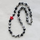 Black and white jade necklace with red howlite star