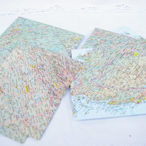 Ten handmade envelopes with from world maps