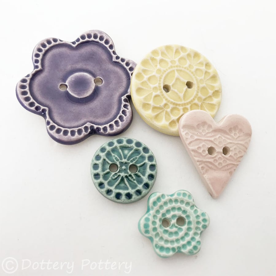 Set of five pale various ceramic handmade buttons