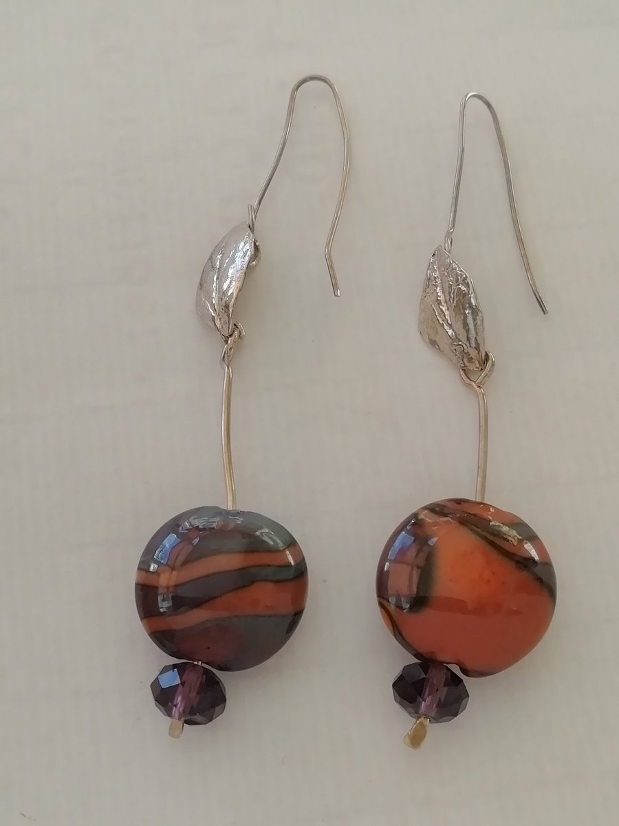Dramatic silver and glass earrings with leaf