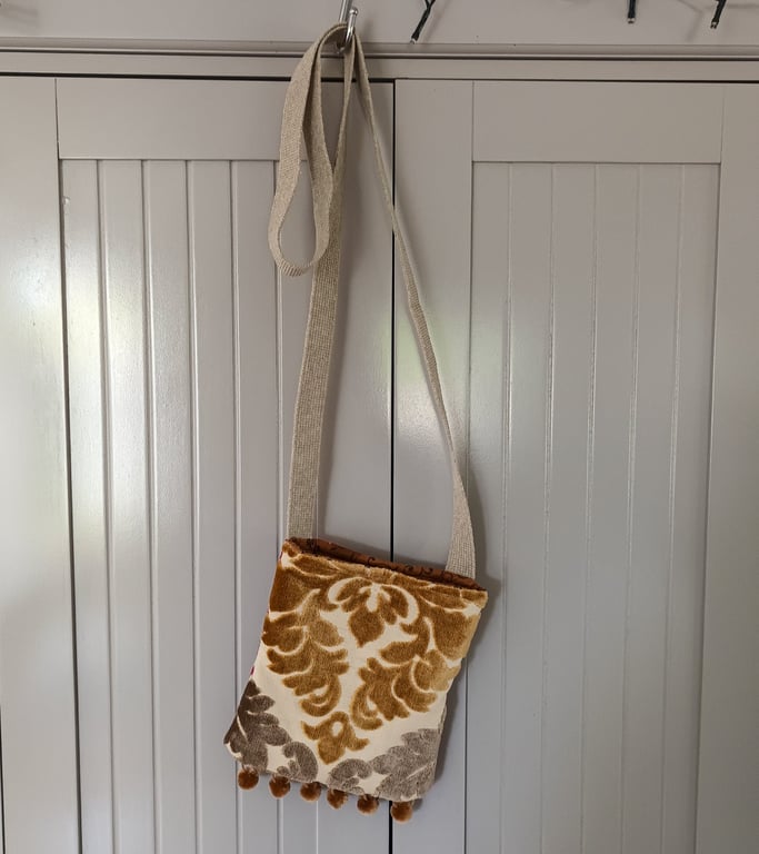 Crossbody handy bag with pompom trim