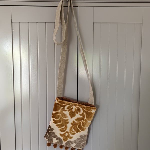 Crossbody handy bag with pompom trim