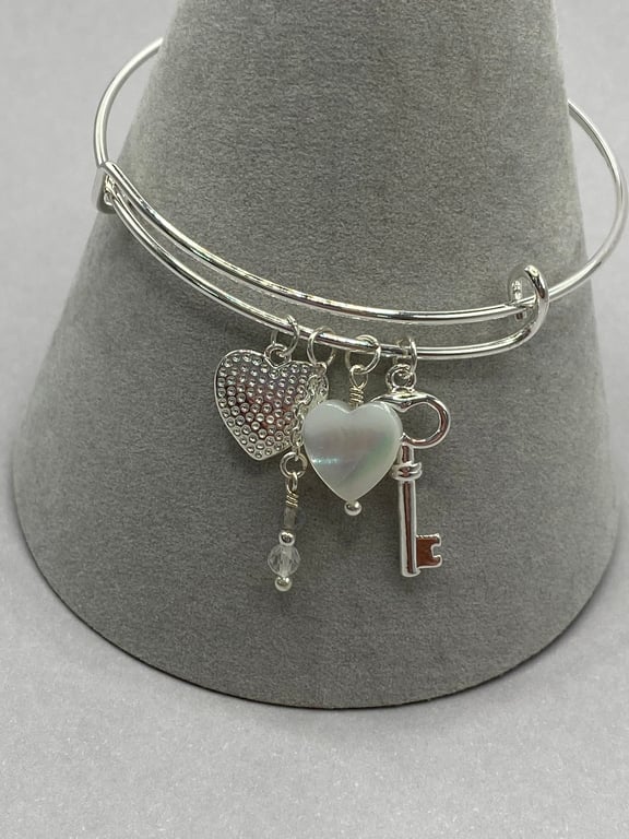 Silver plated charm bangle with silver plated heart and mother of pearl charms