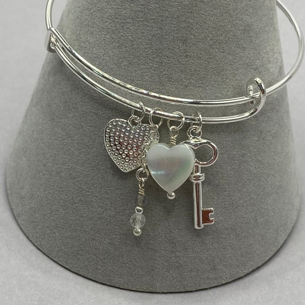 Silver plated charm bangle with silver plated heart and mother of pearl charms