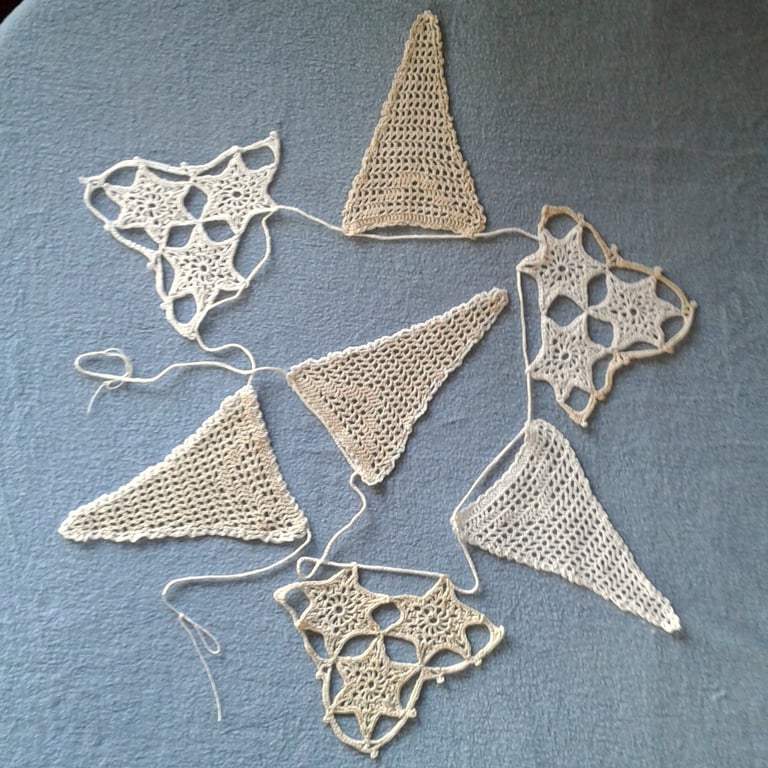 Bunting, hand crocheted lace from a vintage pattern with Filet and stars motifs.