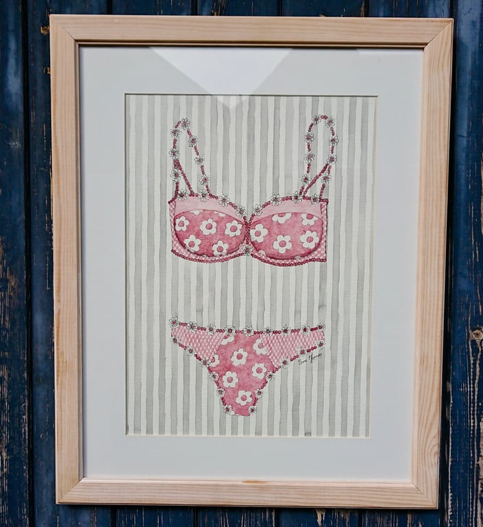 Pink and white bra and knickers painting with daisies on grey striped background