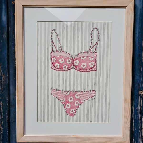 Pink and white bra and knickers painting with daisies on grey striped background
