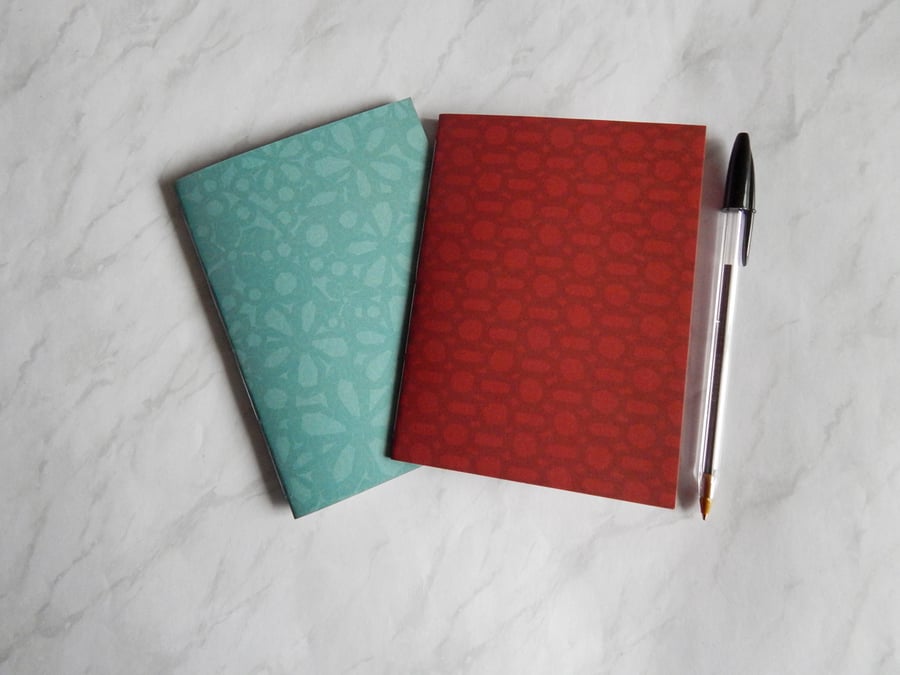 A6 Notebooks - Pair of Patterned 6x4 notebooks in red and aqua. 