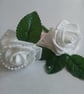 White buttonholes with pearl centre.