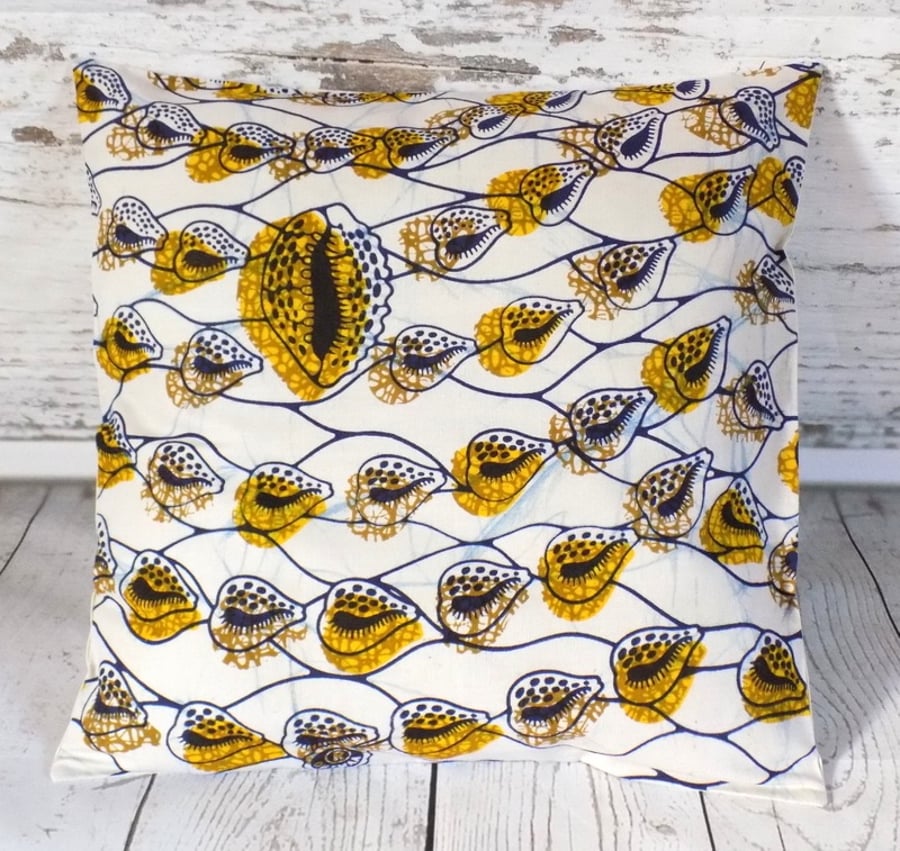 Cushion cover. African wax print, cowrie shells blue and yellow on cream