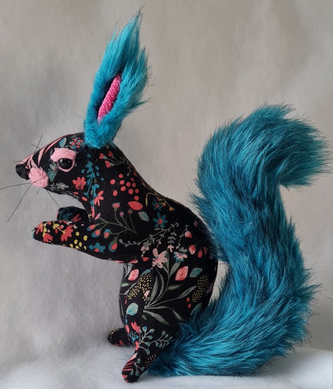 Faux seated floral squirrel with teal tail