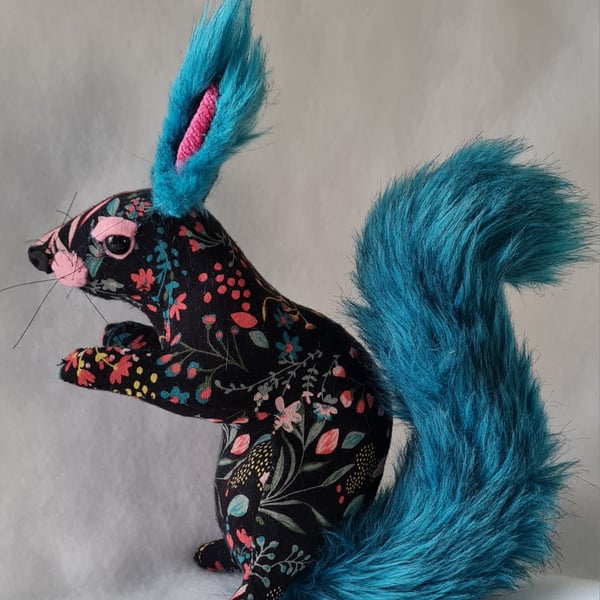 Faux seated floral squirrel with teal tail
