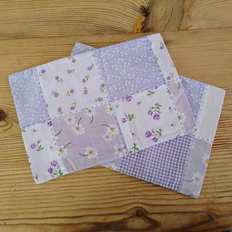 Pair of cushion covers in a pale purple theme with envelope closure.