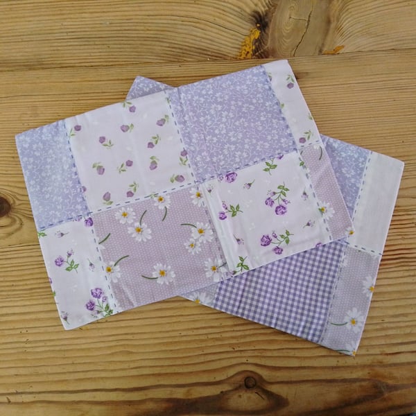 Pair of cushion covers in a pale purple theme with envelope closure.