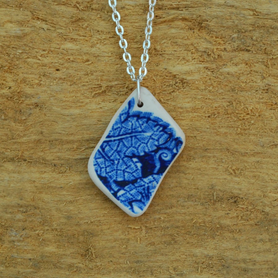 Beach pottery pendant with blue leaf