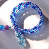 Blue rainbow glass bead bangle bracelet. blues and mauves.