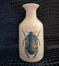 Thrown porcelain vase with beetle design