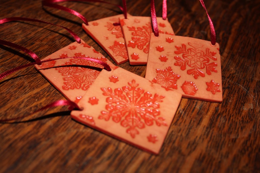 Christmas terracotta ceramic panel embossed with snow flake design and red glaze