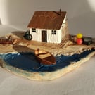 Fishing bothy driftwood house and boat scene.