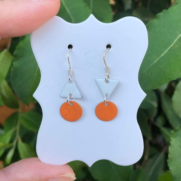 Topsy-turvy Hand enamel earrings. Orange and white enamel earrings. 