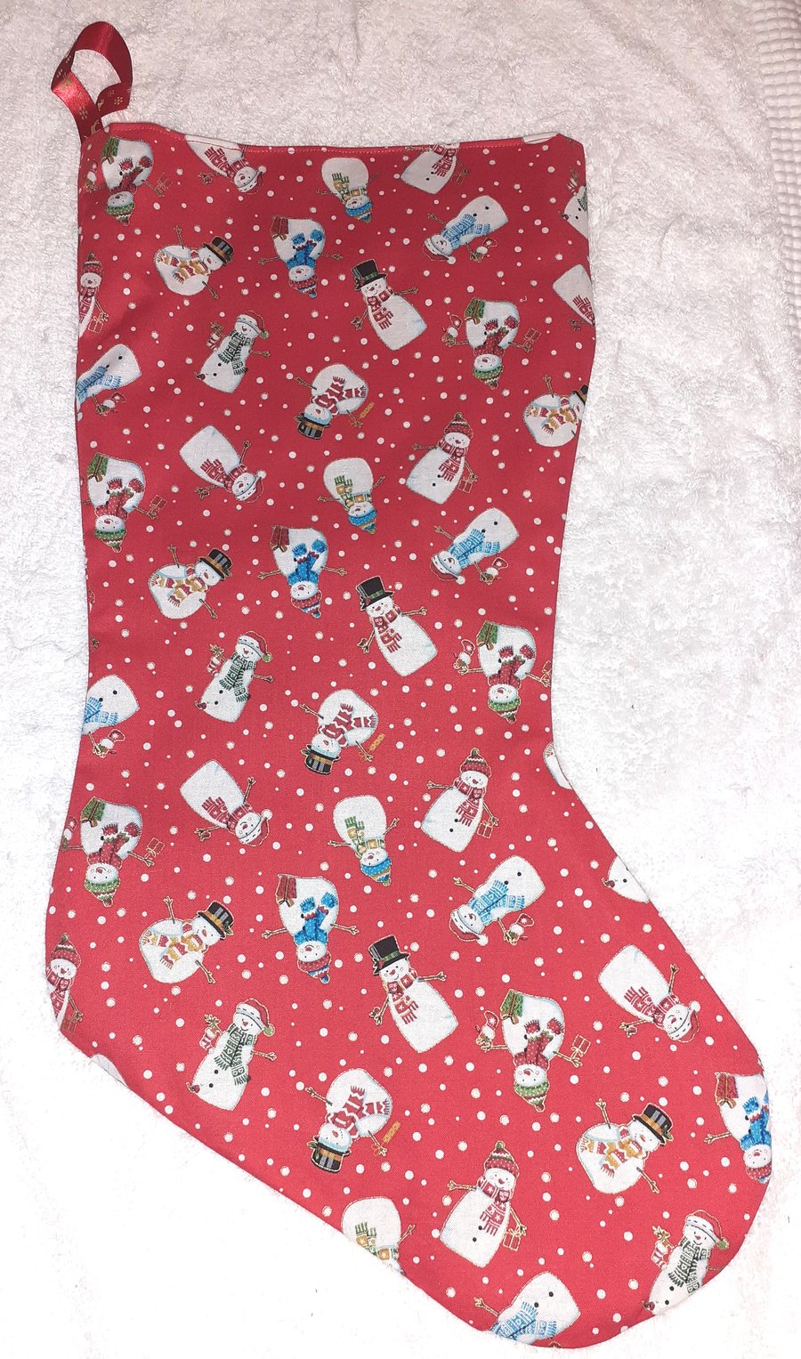 Colourful snowmen on red Christmas stocking