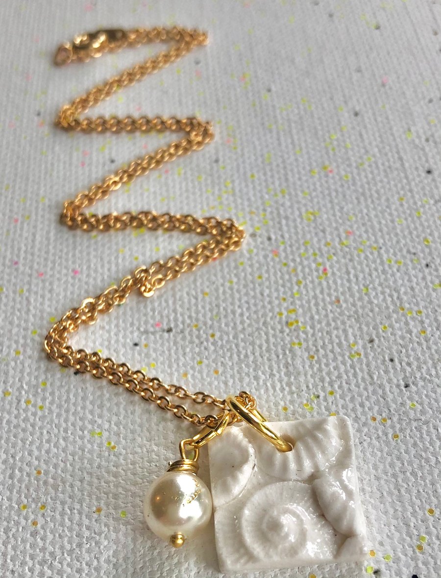 Beautiful handcrafted porcelain shell cluster pendant with vegan Pearl.