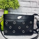 Crossbody bag in Black faux leather with eyelet detail