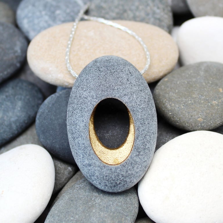 Pebble pendant necklace, nature inspired with a golden hollow centre.