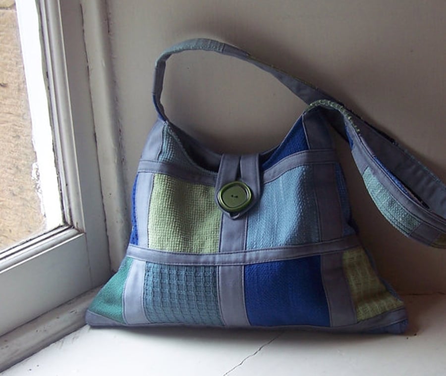 Soft textile shoulder bag in grey, blue and soft green