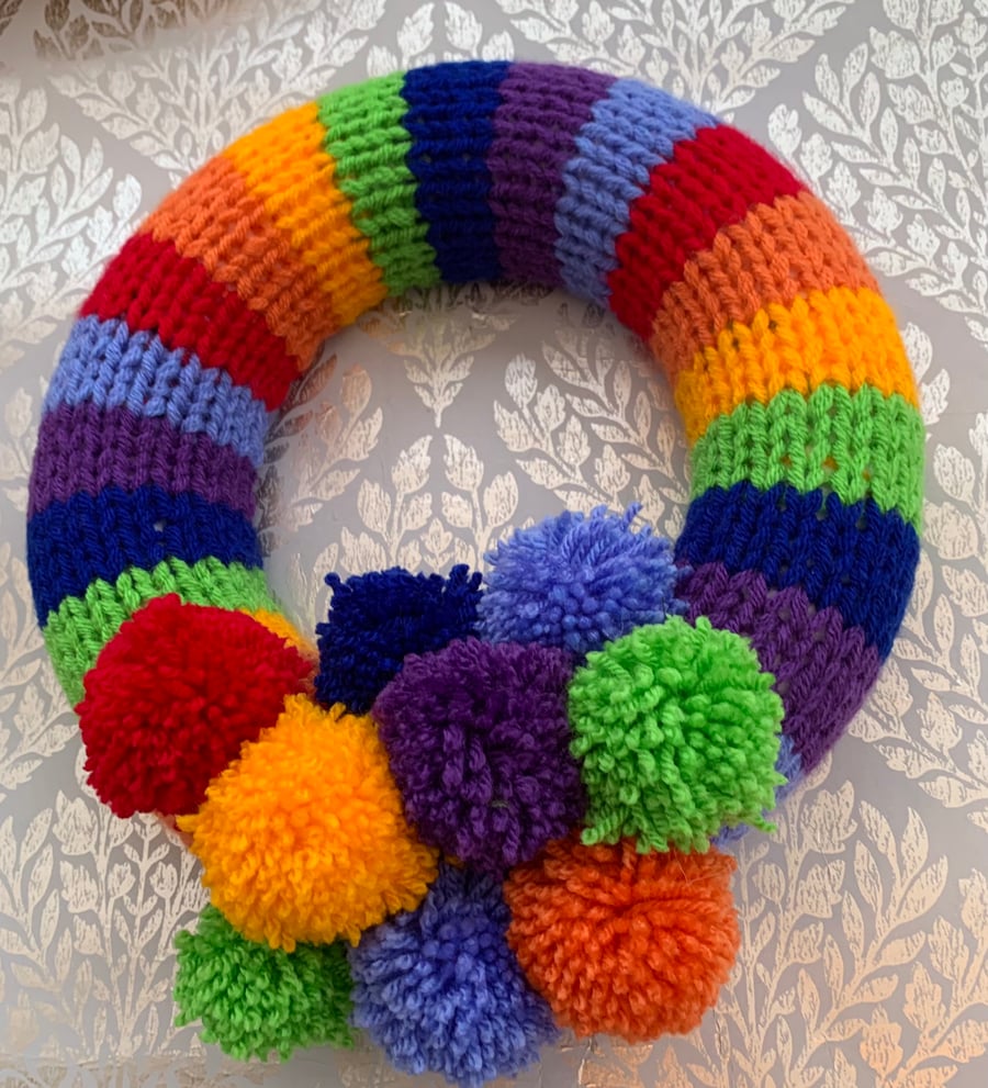 Knitted rainbow  wreath with pom poms 