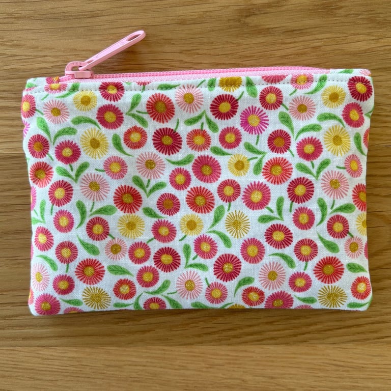 Small zipped fabric coin purse, pouch, in pink floral design.