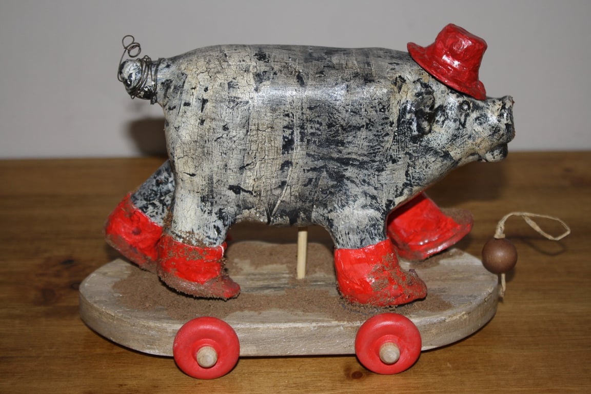 HAND MADE PAPER MACHE RED WELLY PIG WITH HAT ON WHEELS, FOLK ART INSPIRED