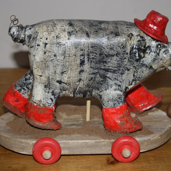 HAND MADE PAPER MACHE RED WELLY PIG WITH HAT ON WHEELS, FOLK ART INSPIRED