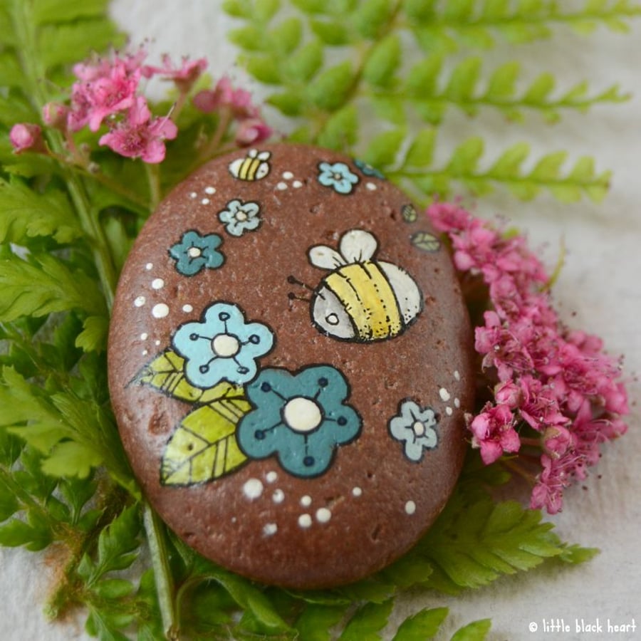 painted pebble - bee and blue flowers